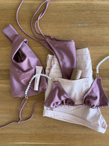 Soarë Blush triangle top flat lay with the Soarë pouch